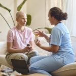 Female nurse discussing with Female Cancer Patient over medicine
