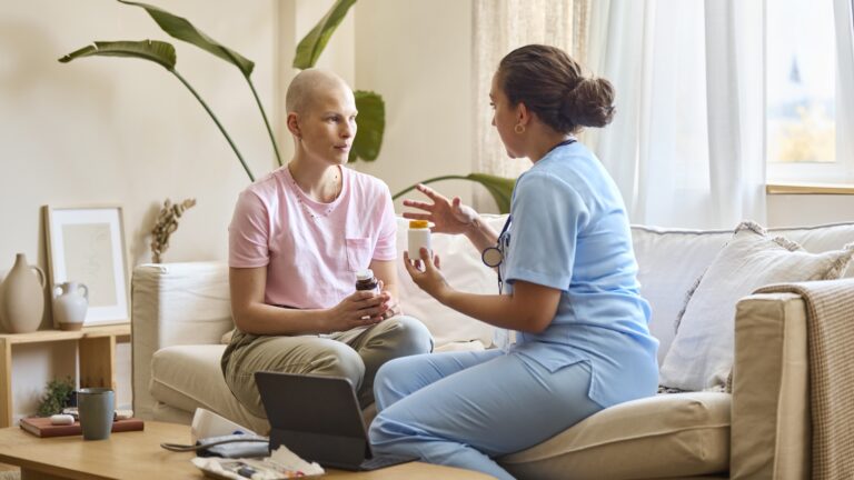 Female nurse discussing with Female Cancer Patient over medicine