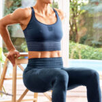 Sporty woman training at home in the sitting room