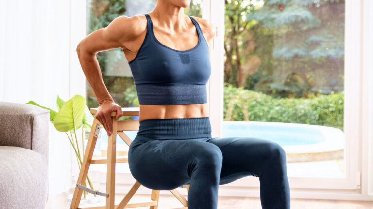 Sporty woman training at home in the sitting room