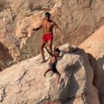 travel-influencer-sparks-outrage-after-tossing-son-off-cliff